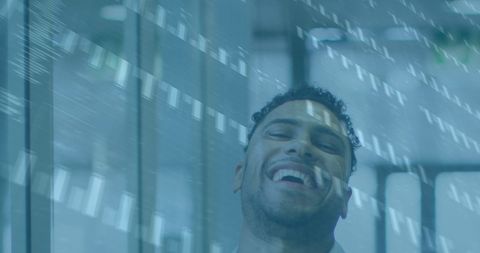 Happy Businessman in Office with Financial Data Overlay