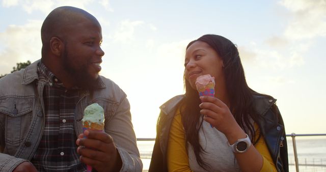 Happy couple interacting with each other on a sunny day. Couple holding ice cream 4k