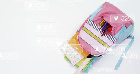 Pastel school backpack with colorful stationery and notebooks on white background