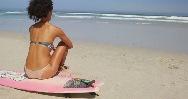 Woman Relaxing on Surfboard at Beach, Enjoying Ocean View - Download Free Stock Images Pikwizard.com