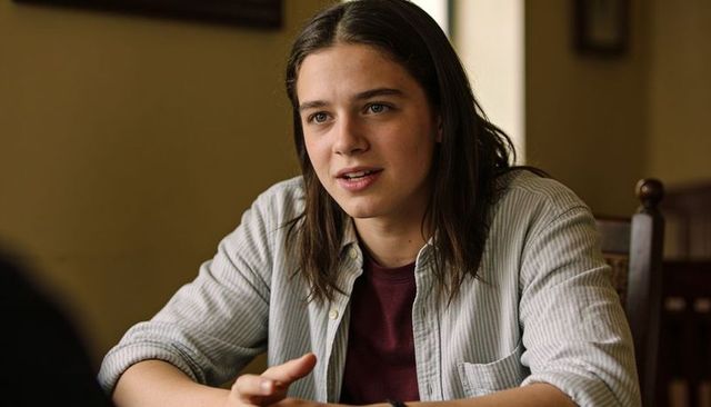 Teen girl talking at dining table, cozy warm home portrait, candid conversation