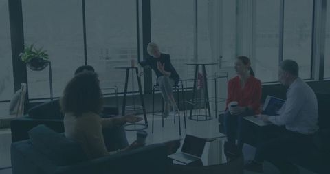 Coworkers Engaged in Collaborative Meeting in Modern Office Lounge