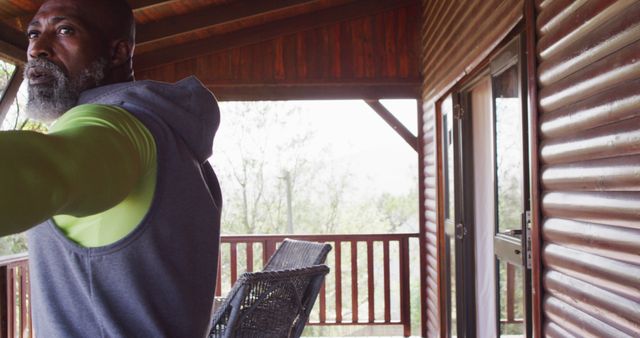 Mature Man Exercising on Cabin Deck in Morning Light - Download Free Stock Images Pikwizard.com