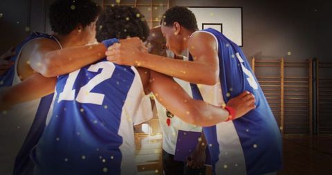 Basketball Team Huddling with Coach on Indoor Gym Court