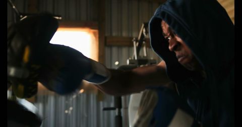 Dedicated African American Boxer Training with Coach in Studio