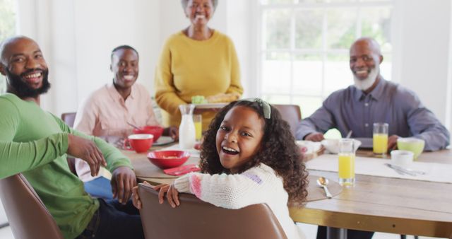 Image portrait of happy african american parents, daughter and grandparents at dining table. Family, domestic life and togetherness concept digitally generated image.