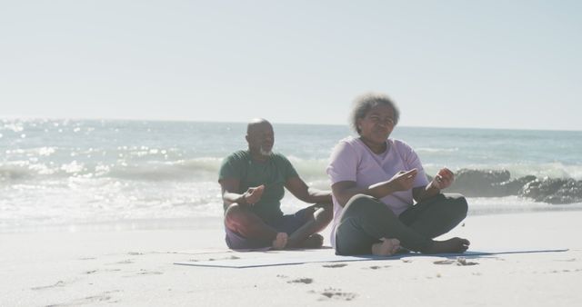 Senior Couple Meditating on Beach by Ocean - Download Free Stock Images Pikwizard.com
