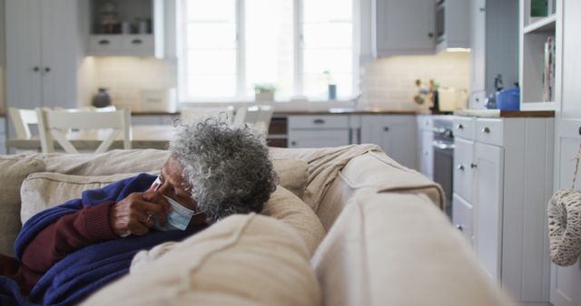 Senior Woman Wearing Face Mask Resting on Sofa at Home - Download Free Stock Images Pikwizard.com