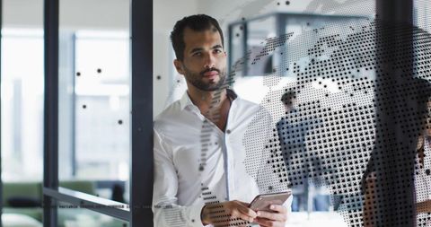 Pensive Businessman with Digital World Overlay in Modern Office
