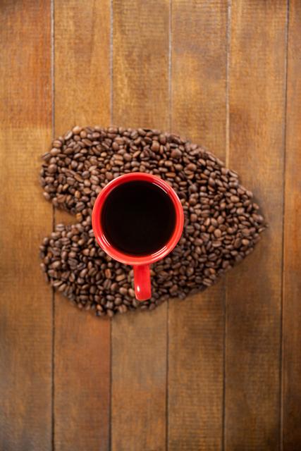 Coffee cup with heart shaped coffee beans - Download Free Stock Photos Pikwizard.com
