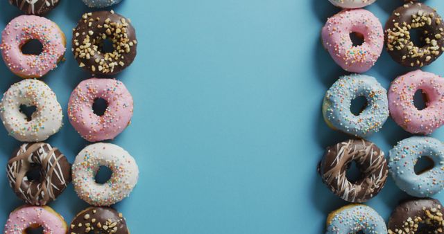 Colorful Donuts Arranged on Blue Background - Download Free Stock Images Pikwizard.com