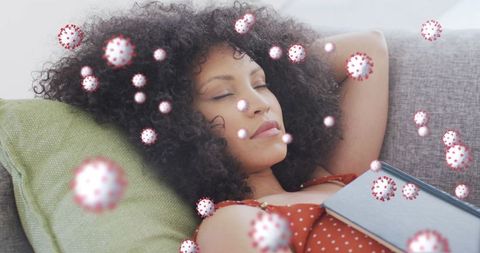 Woman relaxing on sofa with digital virus overlay