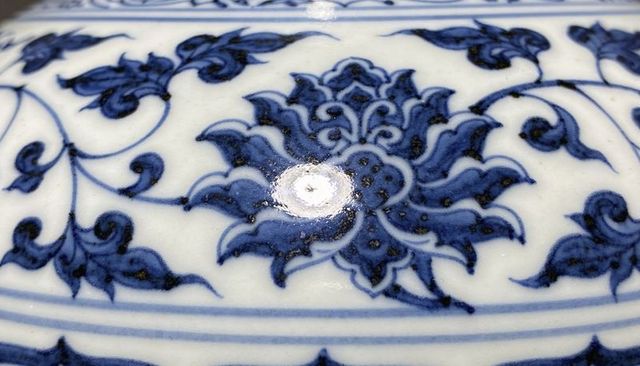 Cobalt blue floral medallion featuring hand-painted white porcelain vessel close-up