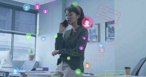 Businesswoman talking on phone with social media icons overlay