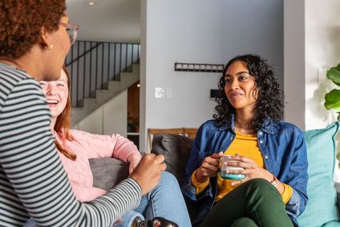 Diverse Friends Enjoy Coffee and Conversation in Modern Living Room