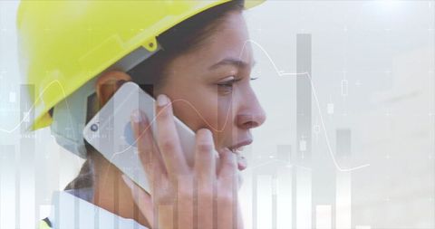 Profile of Asian Female Engineer Talking on Phone with Overlay of Data Graphs