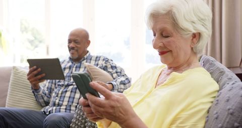 Senior Couple Enjoying Technology in Bright Living Room - Download Free Stock Images Pikwizard.com