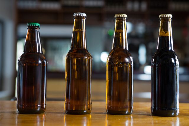 Close-up of arranged beer bottles on the bar counter at restaurant