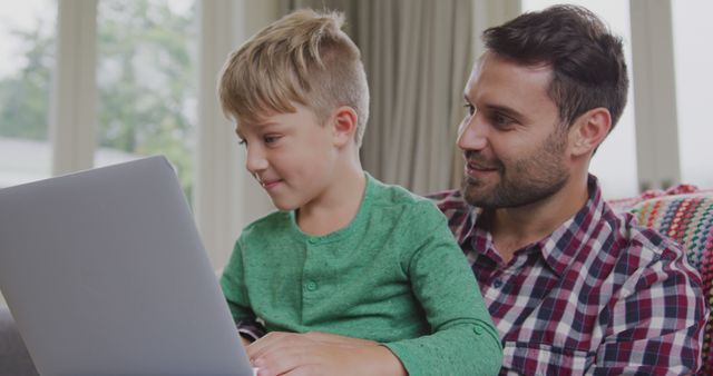 Father and Son Bonding While Using Laptop Together at Home - Download Free Stock Images Pikwizard.com