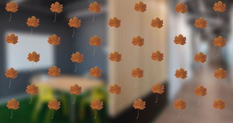 Autumn leaves foreground over blurred restaurant interior