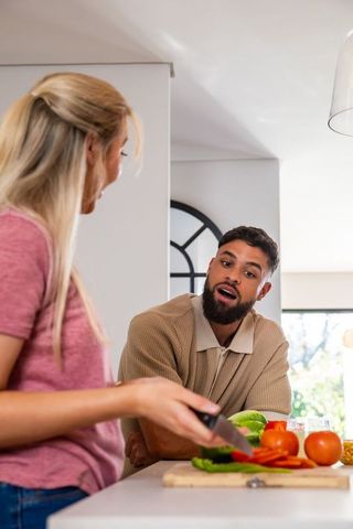 Diverse Couple Preparing Food and Having Fun in Bright Modern Kitchen