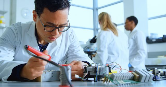 Focused Engineer Working on Circuit Board in Laboratory - Download Free Stock Images Pikwizard.com