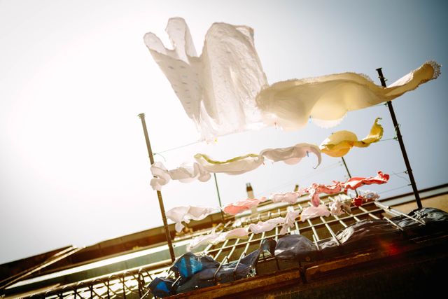 Bright Sunlit Laundry Drying on Clothesline Under Clear Sky - Download Free Stock Images Pikwizard.com