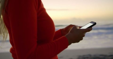 Woman Texting on Smartphone at Beach During Sunset - Download Free Stock Images Pikwizard.com