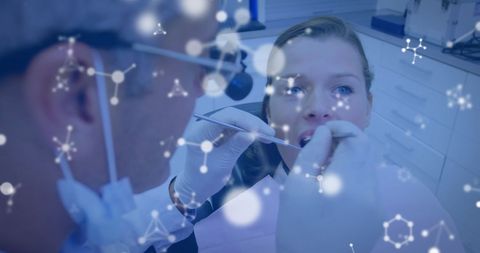 Dentist performing dental checkup with medical interface overlay