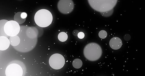 Ethereal Floating White Circles with Particles on Black Background