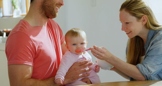 Parents Feeding Baby Girl with Spoon at Home - Download Free Stock Images Pikwizard.com