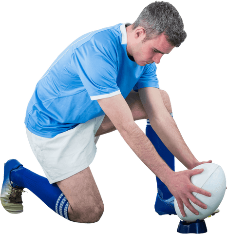 Rugby player concentrating on an accurate drop kick, presented on a transparent background. This image highlights the athleticism and focus typical in rugby sports. Ideal for use in sports magazines, promotional material for rugby events, educational resources, and websites focused on sports training techniques.