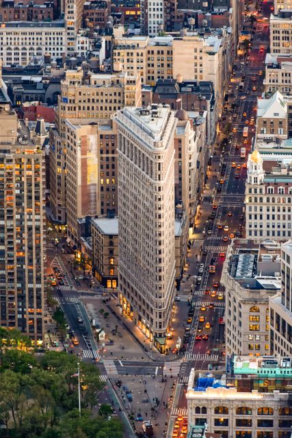 An aerial view capturing the iconic Flatiron Building against the busy backdrop of Manhattan, showcasing the allure of New York City’s historic architecture and vibrant streets. Perfect for projects highlighting urban landscapes, architectural marvels, city life, travel destinations, or New York City features.