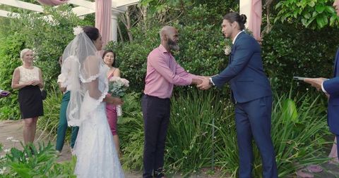 Bride and Groom Exchanging Vows in Lush Outdoor Ceremony