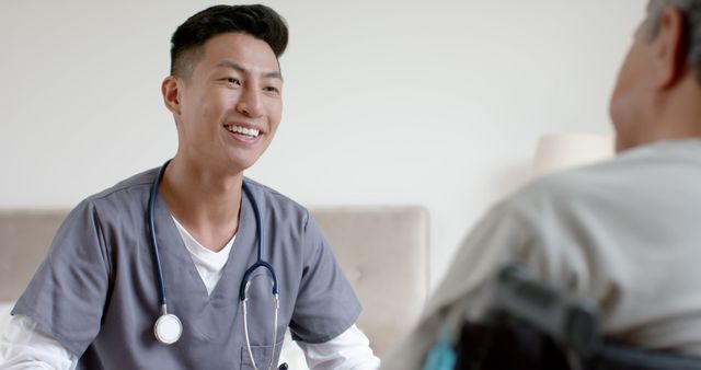 Smiling Male Nurse Assisting Elderly Patient at Care Facility - Download Free Stock Images Pikwizard.com