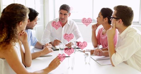Business team meeting with love-themed overlay in office