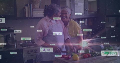 Senior couple cooking together in bright kitchen chopping vegetables sharing laughter