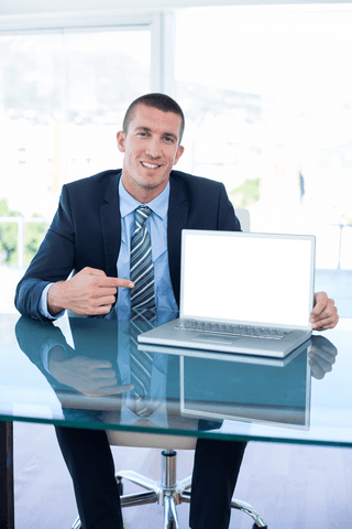 transparent businessman pointing at blank laptop screen in office - Download Free Stock Videos Pikwizard.com