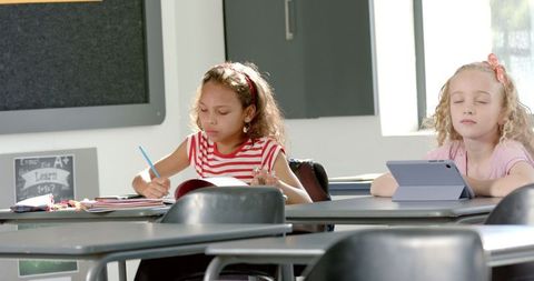 Elementary schoolchildren in classroom engaging in learning activities