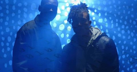 Silhouette of Two Men in Urban Blue Abstract Studio Lighting