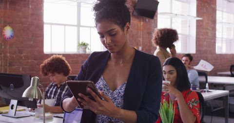 Professional Woman Using Tablet in Creative Office Environment - Download Free Stock Images Pikwizard.com