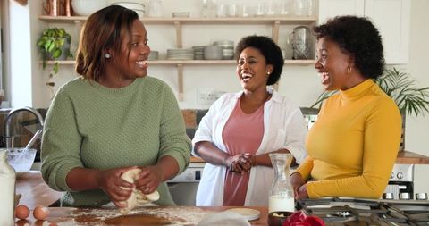 Joyful Friends Cooking Together in Cozy Home Kitchen