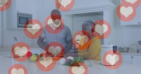 Senior Couple Cooking Healthy Meal with Digital Hearts Overlay