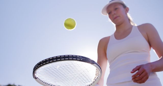 Female Tennis Player Balancing Tennis Ball with Racket on Sunny Day - Download Free Stock Images Pikwizard.com