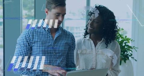 Diverse Professionals Collaborating on Laptop in Bright Office