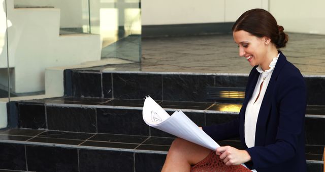 Businesswoman Reviewing Documents on Steps Outdoors - Download Free Stock Images Pikwizard.com