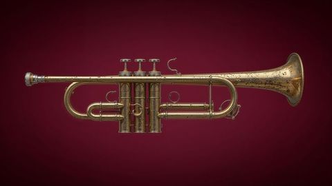 Aged brass trumpet in studio with maroon background