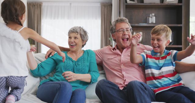 Happy Grandparents Playing with Grandchildren on Sofa at Home - Download Free Stock Images Pikwizard.com