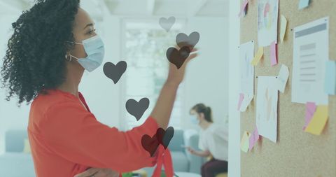 Businesswoman Reads Memo in Mask with Heart Icons Overlay
