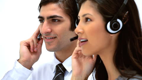 Customer Support Team Using Headsets in Office